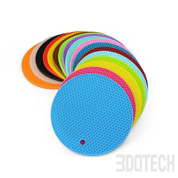 Multi-color round silicone trivet mats with intricate flower fan pattern for kitchen heat protection