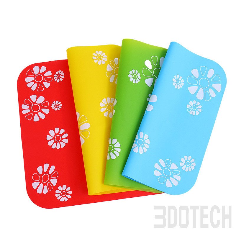 Large square silicone mat rolled up to show flexible food-grade material in assorted bright colors.