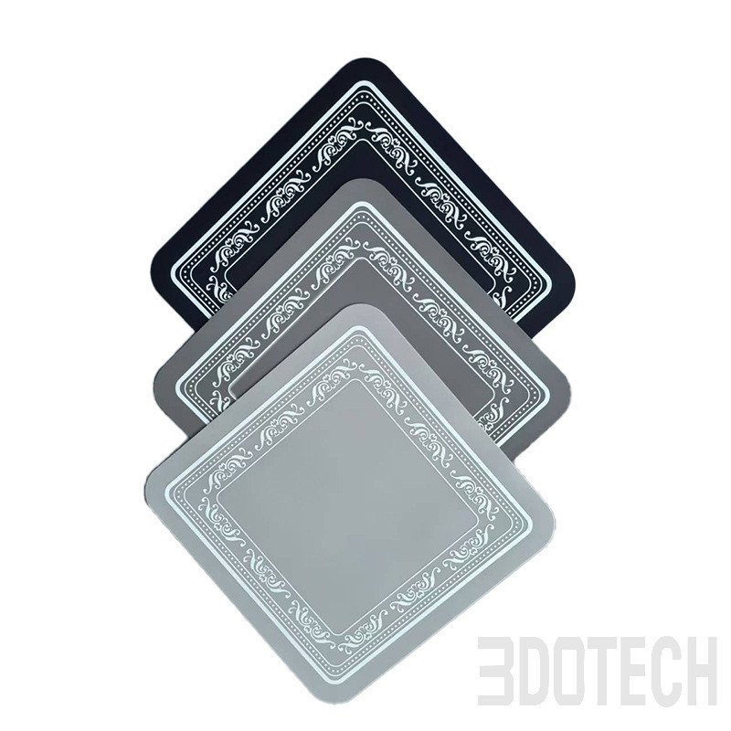 Navy and gray square silicone counter mats with embossed spiral texture and rounded corners.